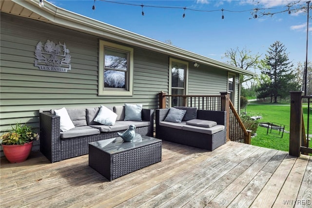 wooden terrace with an outdoor living space and a yard