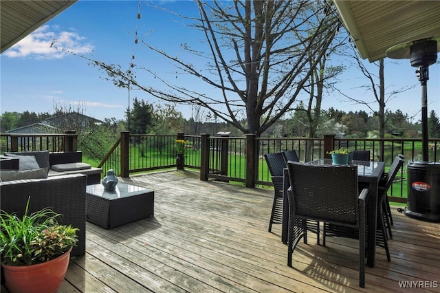 wooden terrace with an outdoor living space and outdoor dining area