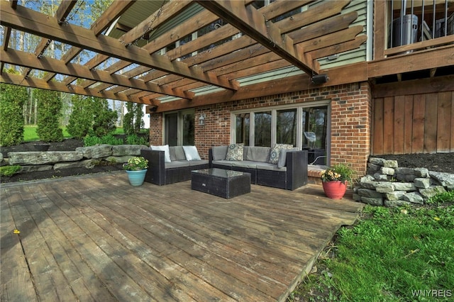 wooden deck with an outdoor living space and a pergola