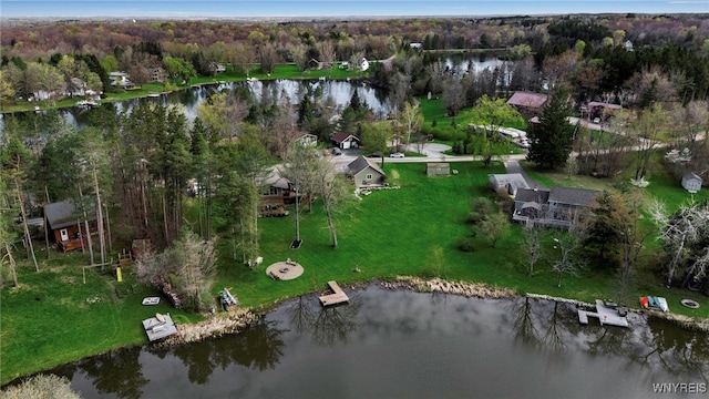 birds eye view of property with a water view and a view of trees