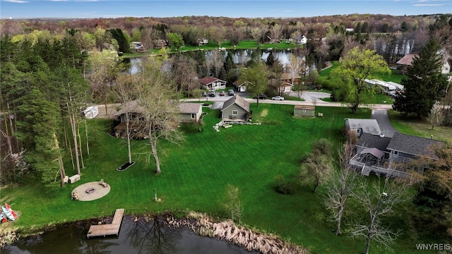birds eye view of property with a view of trees and a water view
