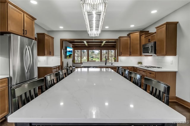 kitchen featuring recessed lighting, a sink, appliances with stainless steel finishes, and a large island