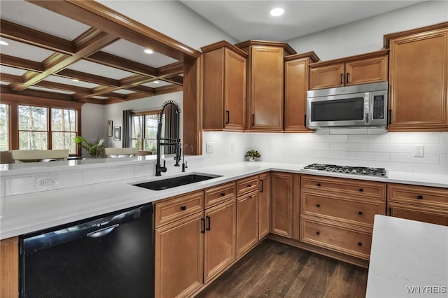 kitchen with brown cabinetry, stainless steel appliances, recessed lighting, dark wood-type flooring, and beamed ceiling