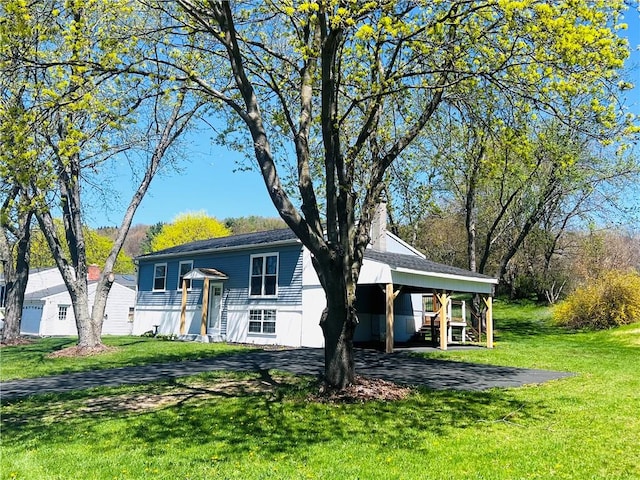 71 Redwing Ln, Horseheads, NY 14845 - split foyer home featuring a front lawn, a chimney, and a carport
