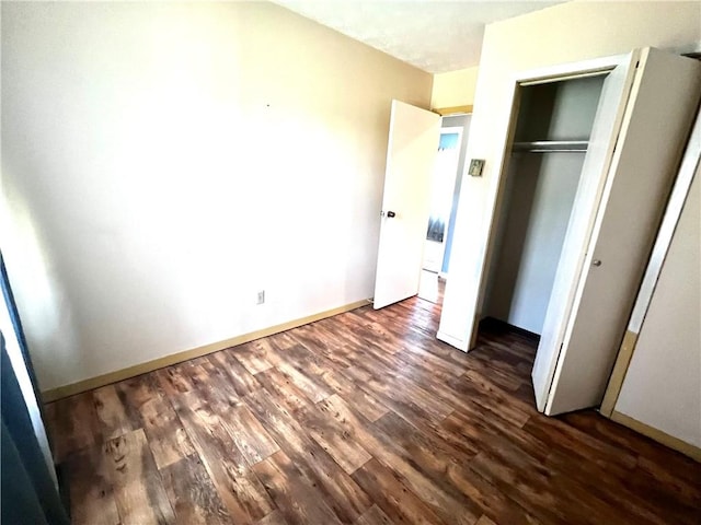 71 Redwing Ln, Horseheads, NY 14845 - unfurnished bedroom with dark wood-style flooring and a closet