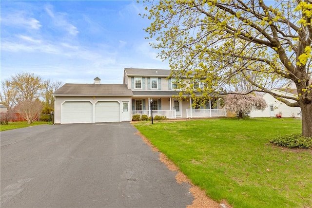 view of front facade with an attached garage, a front lawn, covered porch, and driveway
