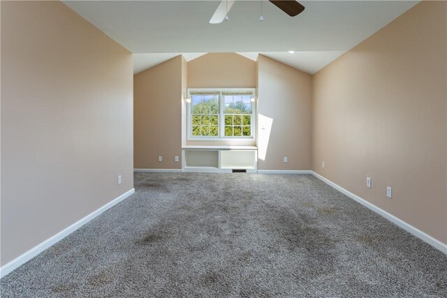 unfurnished room with visible vents, lofted ceiling, baseboards, a ceiling fan, and carpet