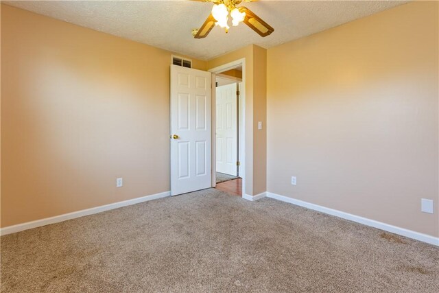 unfurnished bedroom with visible vents, a ceiling fan, baseboards, a textured ceiling, and carpet flooring