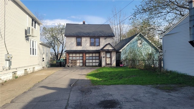 147 Roswell Ave, Tonawanda-Town, NY 14207 - exterior space with aphalt driveway, fence, a lawn, a chimney, and an attached garage