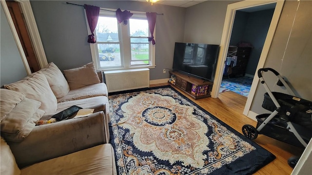 147 Roswell Ave, Tonawanda-Town, NY 14207 - living room featuring baseboards, wood finished floors, and radiator