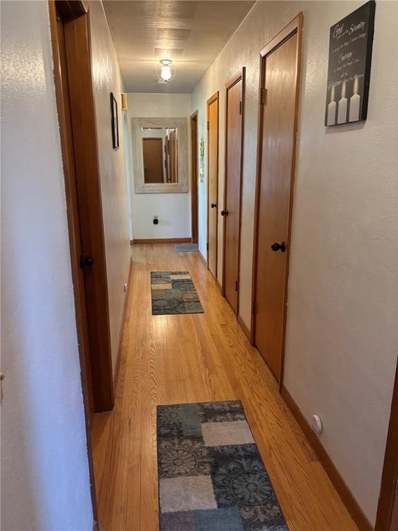 1001 W Broad St, Horseheads, NY 14845 - corridor with baseboards and light wood-style flooring