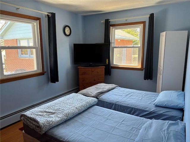 1001 W Broad St, Horseheads, NY 14845 - bedroom with a baseboard heating unit and wood finished floors