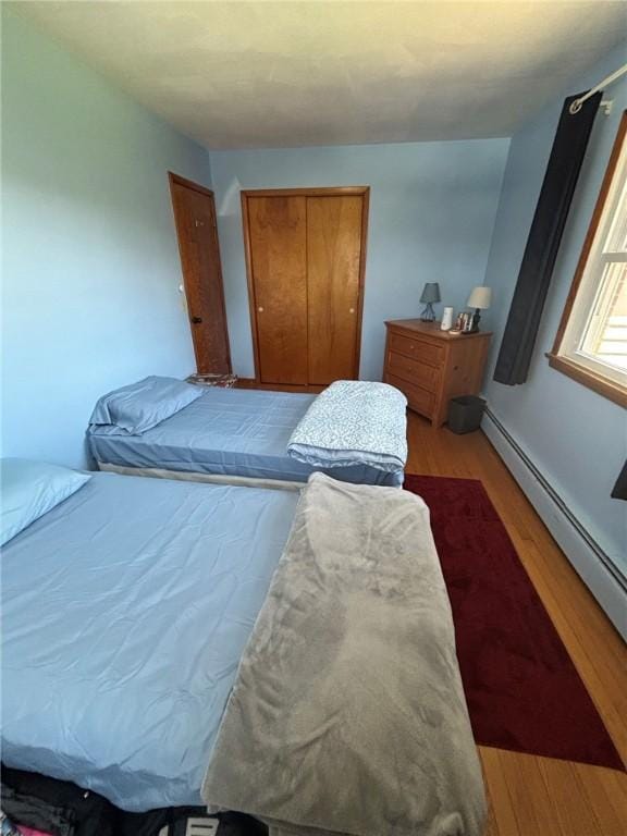 1001 W Broad St, Horseheads, NY 14845 - bedroom with a closet, baseboard heating, and wood finished floors