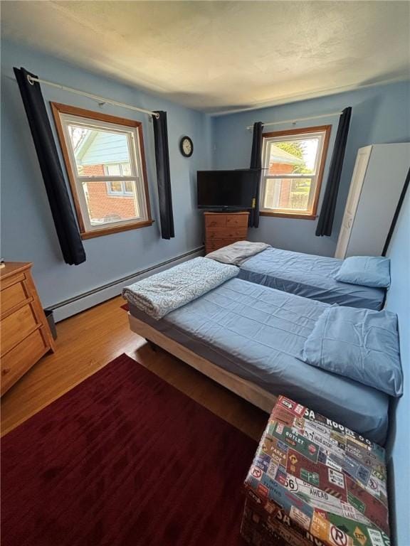 1001 W Broad St, Horseheads, NY 14845 - bedroom with a baseboard radiator and wood finished floors