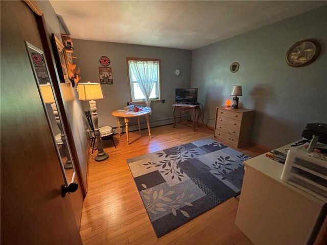 1001 W Broad St, Horseheads, NY 14845 - bedroom with a baseboard heating unit and wood finished floors
