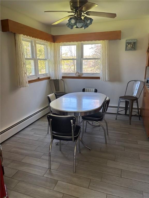 1001 W Broad St, Horseheads, NY 14845 - dining room with a ceiling fan, a baseboard heating unit, wood finished floors, and baseboard heating