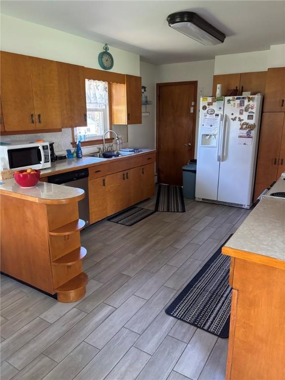 1001 W Broad St, Horseheads, NY 14845 - kitchen with a sink, open shelves, white appliances, and wood tiled floor
