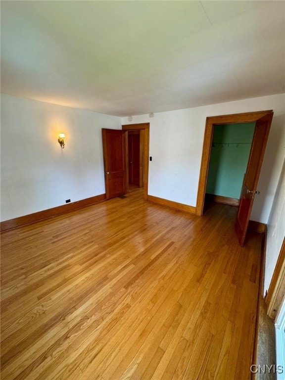 empty room with light wood-style floors and baseboards