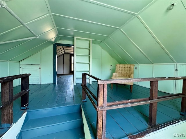 additional living space featuring wood-type flooring and vaulted ceiling