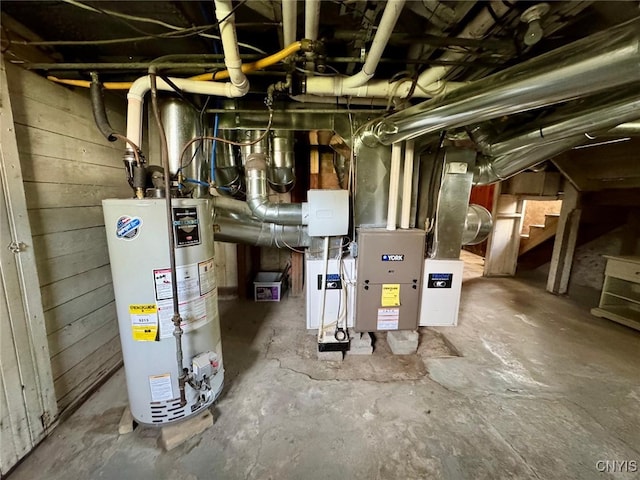 utility room with heating unit and gas water heater
