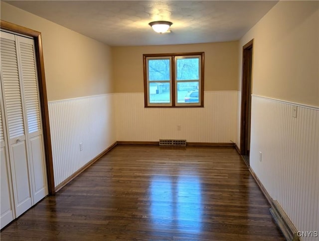 134 Malden Rd, Salina, NY 13211 - unfurnished bedroom with visible vents, dark wood-style flooring, wainscoting, and a closet