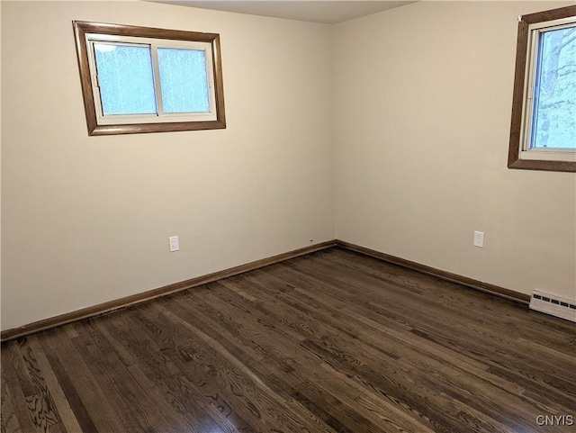 134 Malden Rd, Salina, NY 13211 - empty room featuring baseboards, a baseboard radiator, and dark wood-style flooring