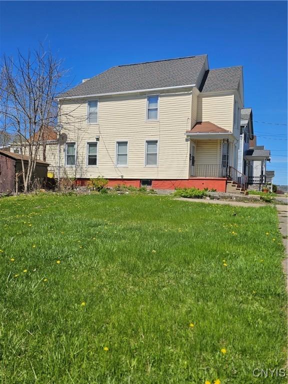 rear view of house with a yard