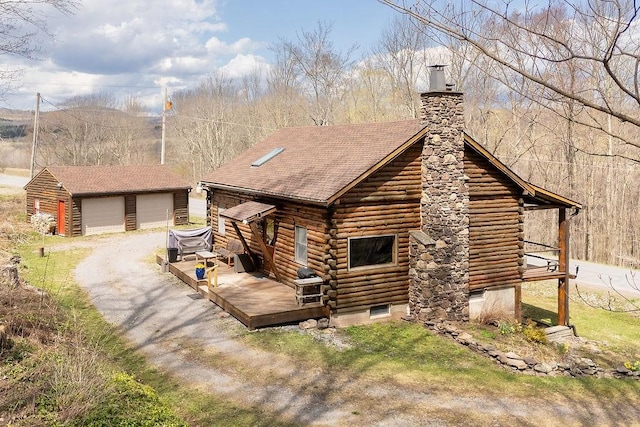 851 Lower Meeker Hollow Rd, Roxbury, NY 12474 - view of front of house featuring a garage, a deck, a chimney, log siding, and an outbuilding
