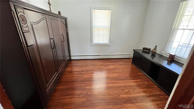 3319 Riverside Dr, Scio, NY 14895 - corridor with dark wood-style flooring and a baseboard heating unit