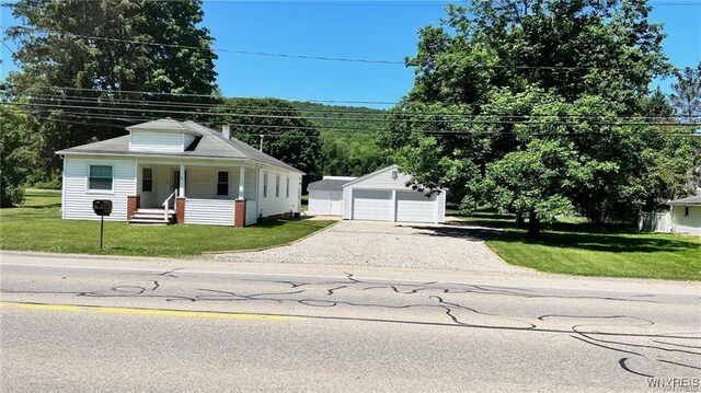 3319 Riverside Dr, Scio, NY 14895 - bungalow-style home with covered porch, an outbuilding, a front yard, and a detached garage