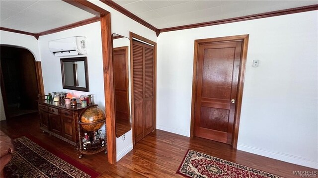 3319 Riverside Dr, Scio, NY 14895 - hall with ornamental molding, wood finished floors, baseboards, a wall mounted air conditioner, and arched walkways