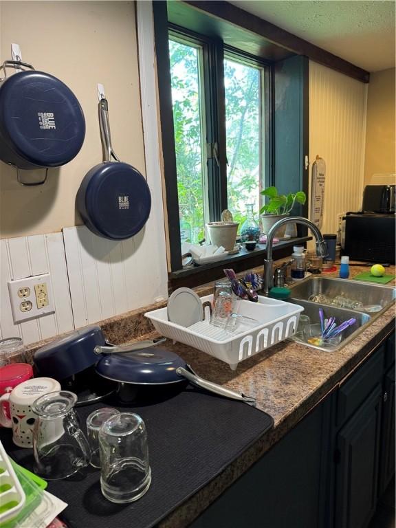 kitchen with a sink and a textured ceiling