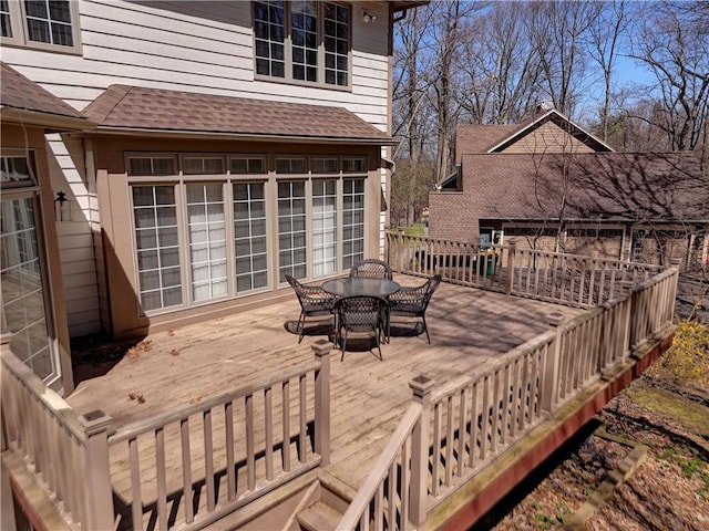 wooden terrace with outdoor dining space