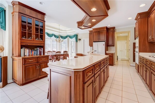 kitchen with recessed lighting, light countertops, light tile patterned floors, and white appliances