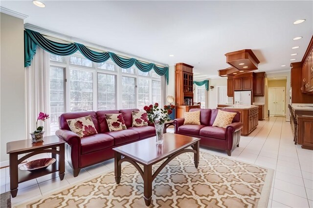 living room with recessed lighting, ornamental molding, and light tile patterned flooring