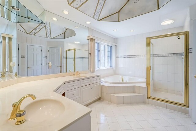 bathroom with a garden tub, a sink, a stall shower, and tile patterned floors
