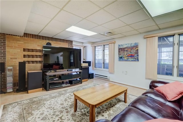 living room with visible vents, baseboards, a drop ceiling, and baseboard heating