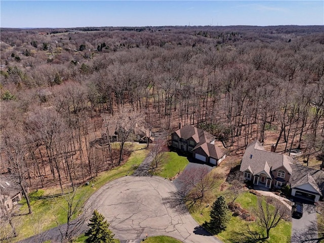 drone / aerial view featuring a wooded view