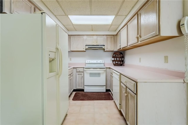 kitchen featuring white appliances, under cabinet range hood, a paneled ceiling, and light countertops