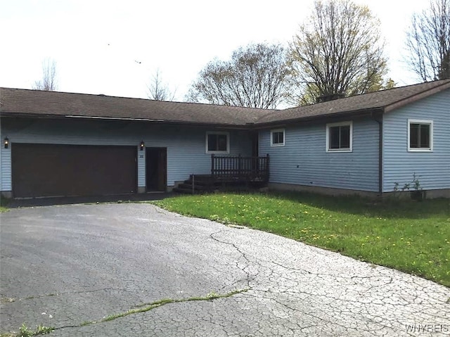 view of front of house with an attached garage, driveway, and a front yard