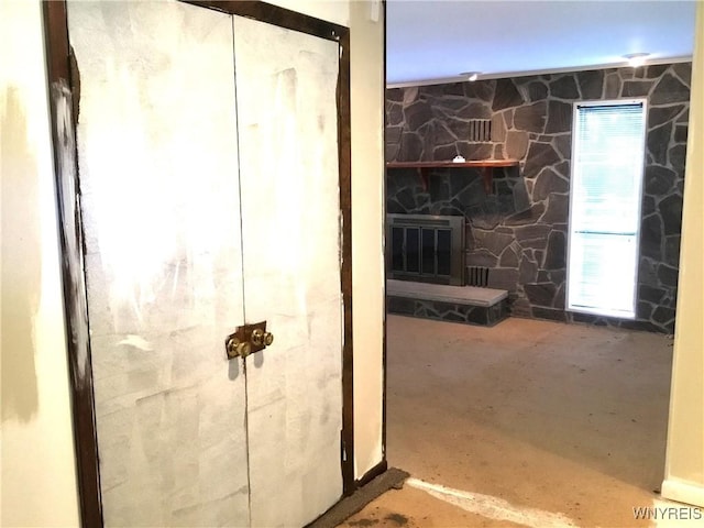 bathroom featuring a fireplace and concrete flooring