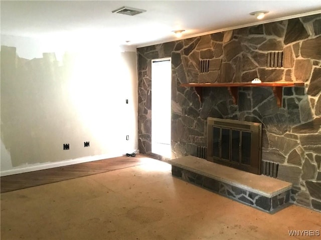 interior details with baseboards, visible vents, and a stone fireplace