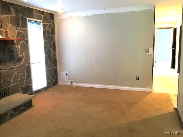 interior space with baseboards and a stone fireplace