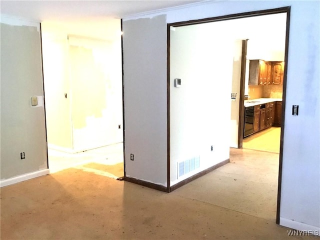 interior space with concrete flooring, baseboards, and visible vents