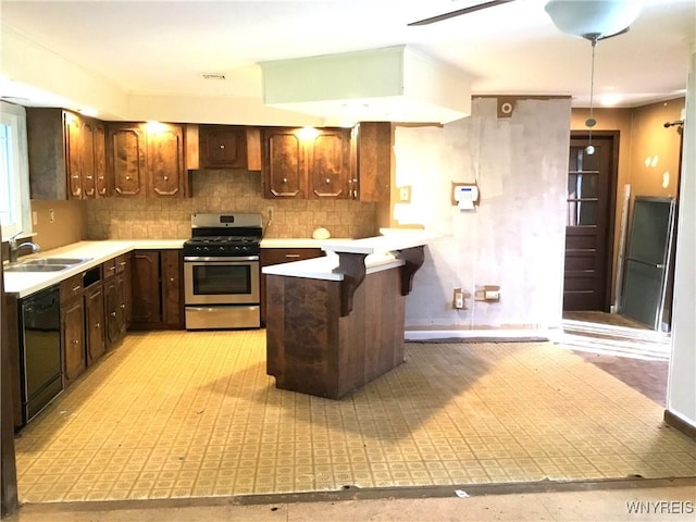 kitchen featuring a sink, stainless steel range with gas stovetop, black dishwasher, and light countertops