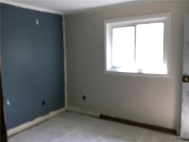 unfurnished room featuring baseboards