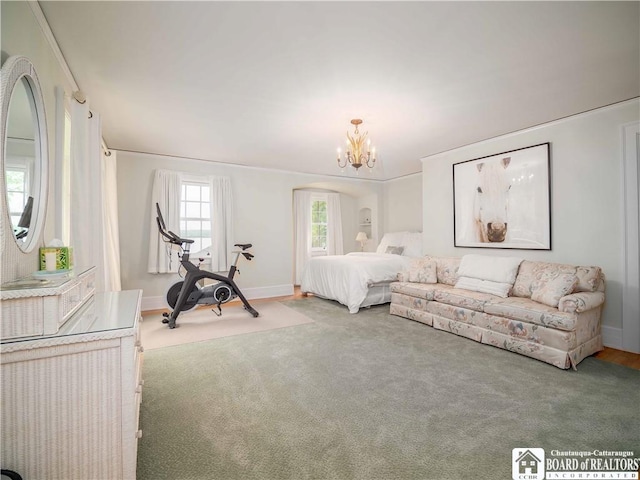carpeted bedroom featuring baseboards, arched walkways, and a notable chandelier