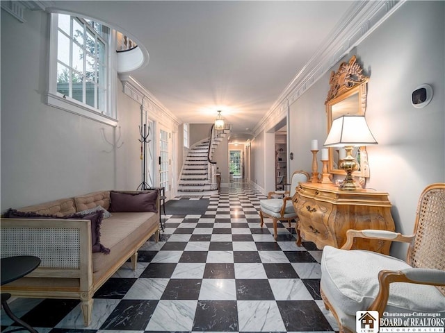 hall featuring ornamental molding, a healthy amount of sunlight, and stairway