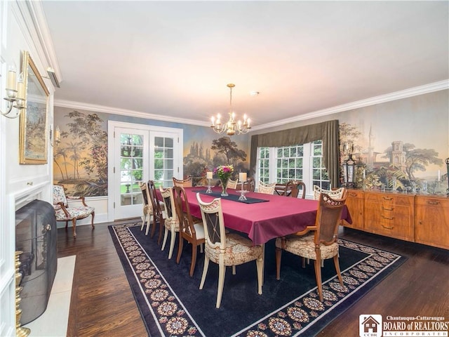 dining area featuring crown molding, a chandelier, wainscoting, and wood finished floors