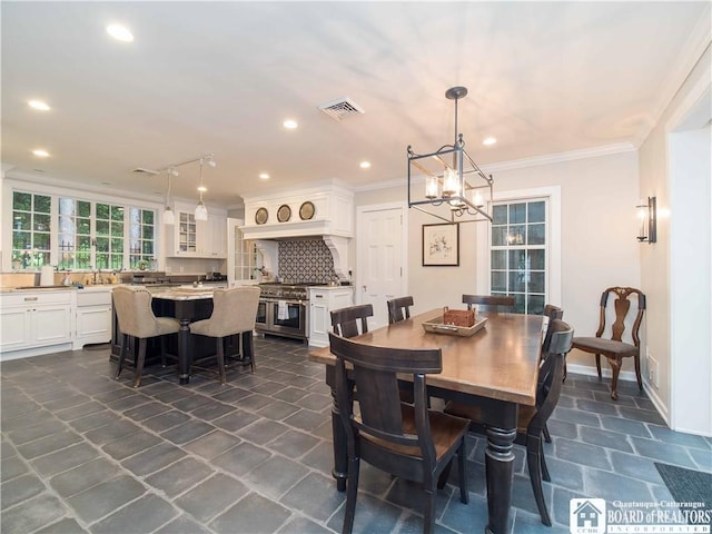 dining area with crown molding, a notable chandelier, recessed lighting, baseboards, and visible vents